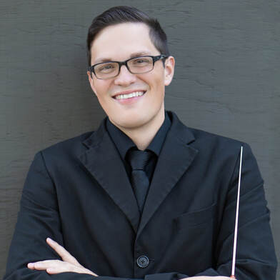 Man smiling holding a baton